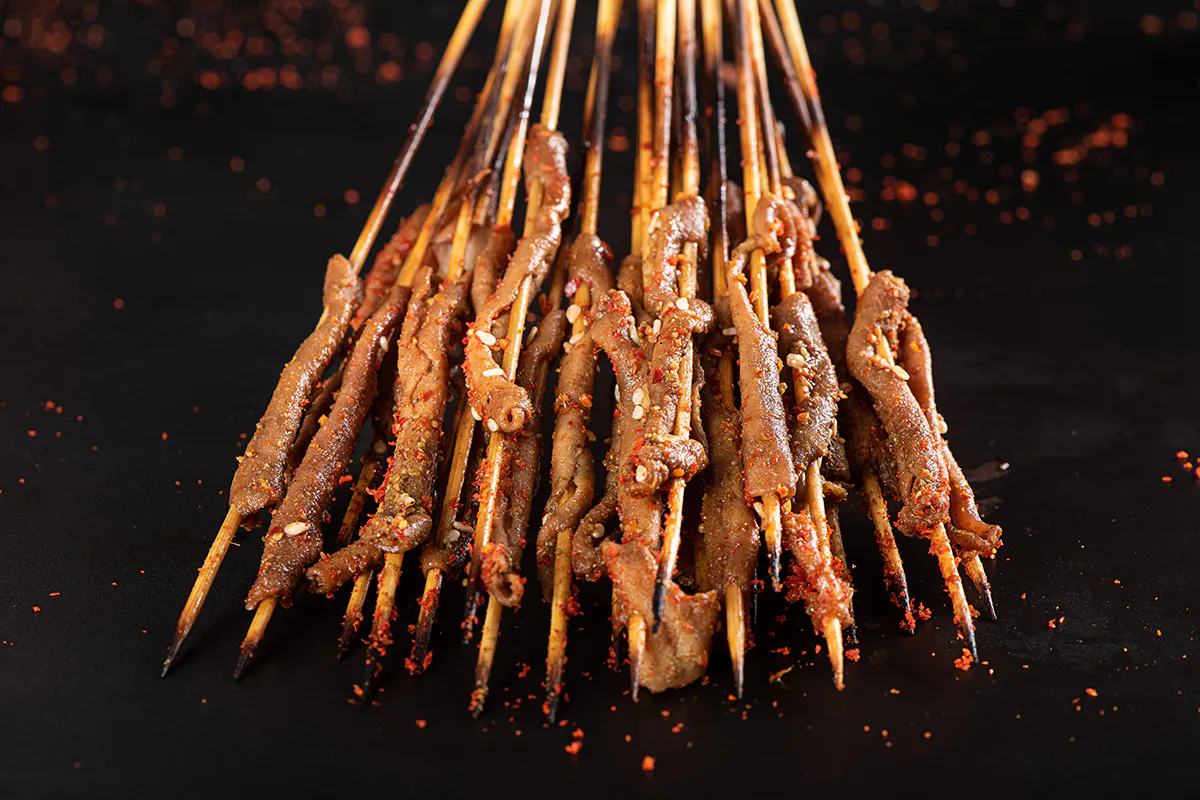 Spicy grilled beef skewers with sesame and chili at Aquaman BBQ, a Barbecue Restaurant in Queens