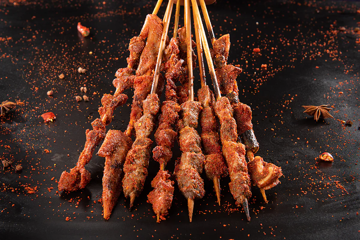 Spicy grilled meat skewers with chili seasoning at Aquaman BBQ, a Barbecue Restaurant in Queens